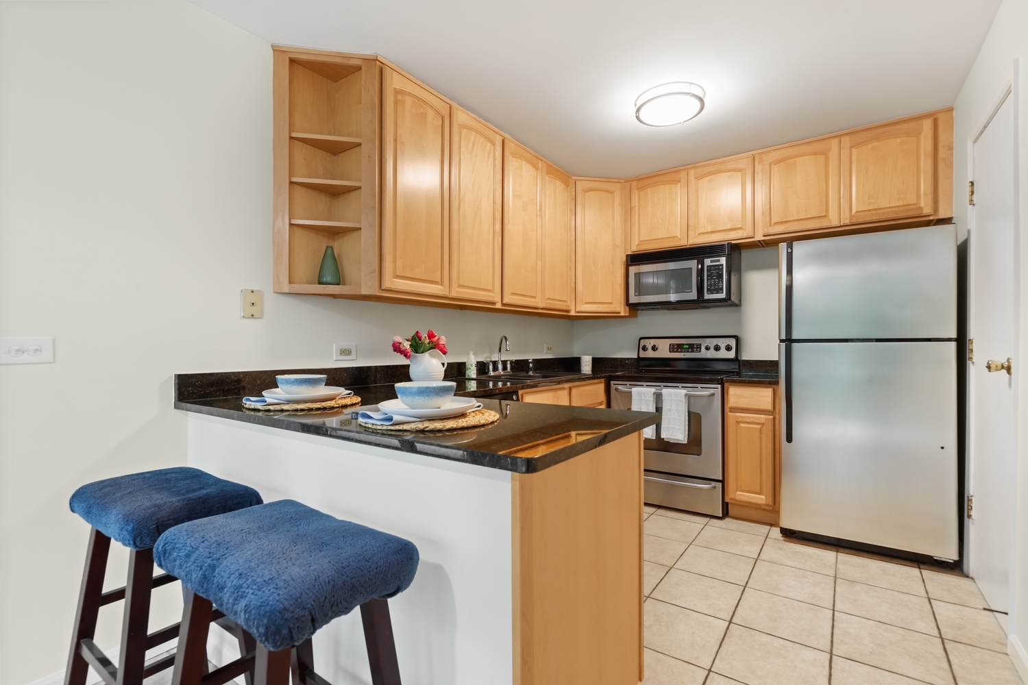 5902 Forest View Road, Unit 2D Lisle, IL 60532 - Photo 8 of 27 a kitchen with stainless steel appliances granite countertop a stove a sink and a refrigerator