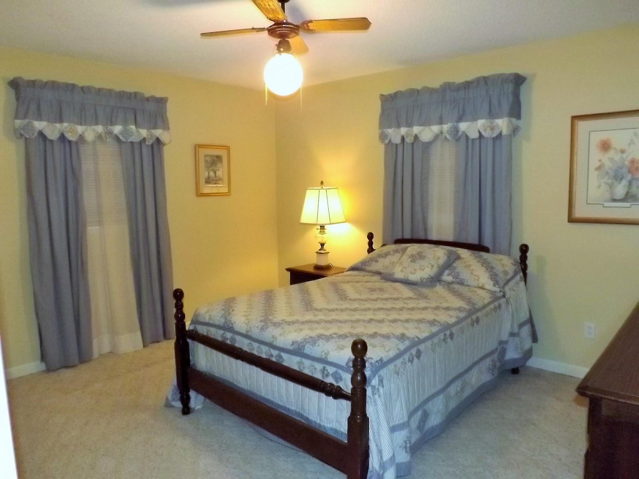 154 Hodge Road Manchester, TN 37355 - Photo 13 of 20 a bed sitting in a bedroom next to a window