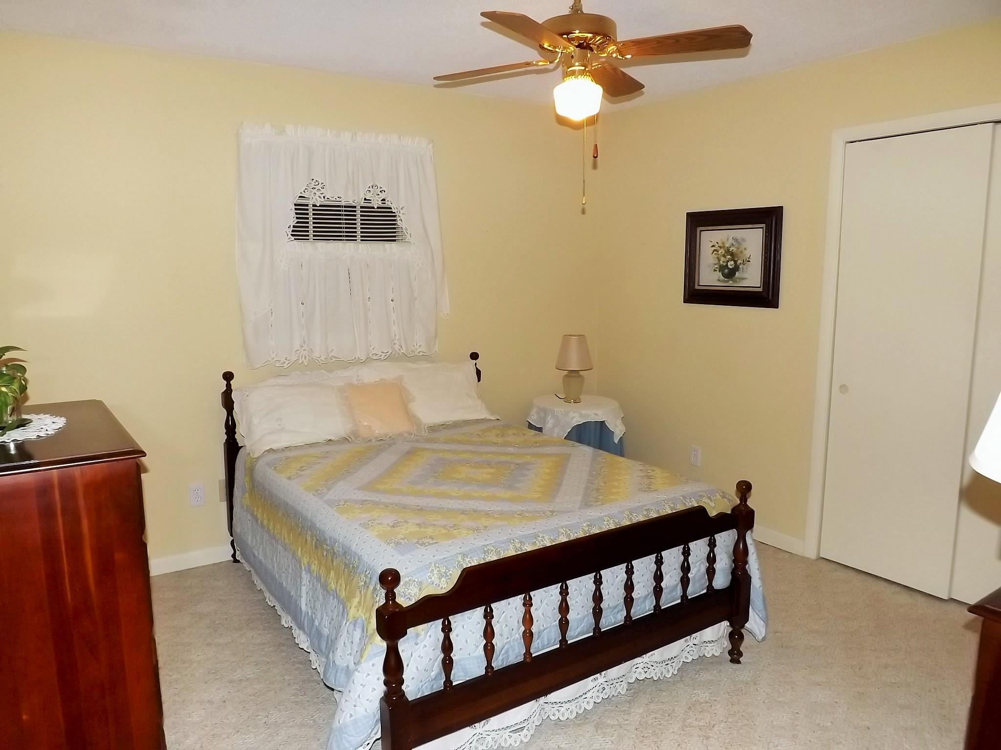 154 Hodge Road Manchester, TN 37355 - Photo 17 of 20 a bed sitting in a bedroom next to a window