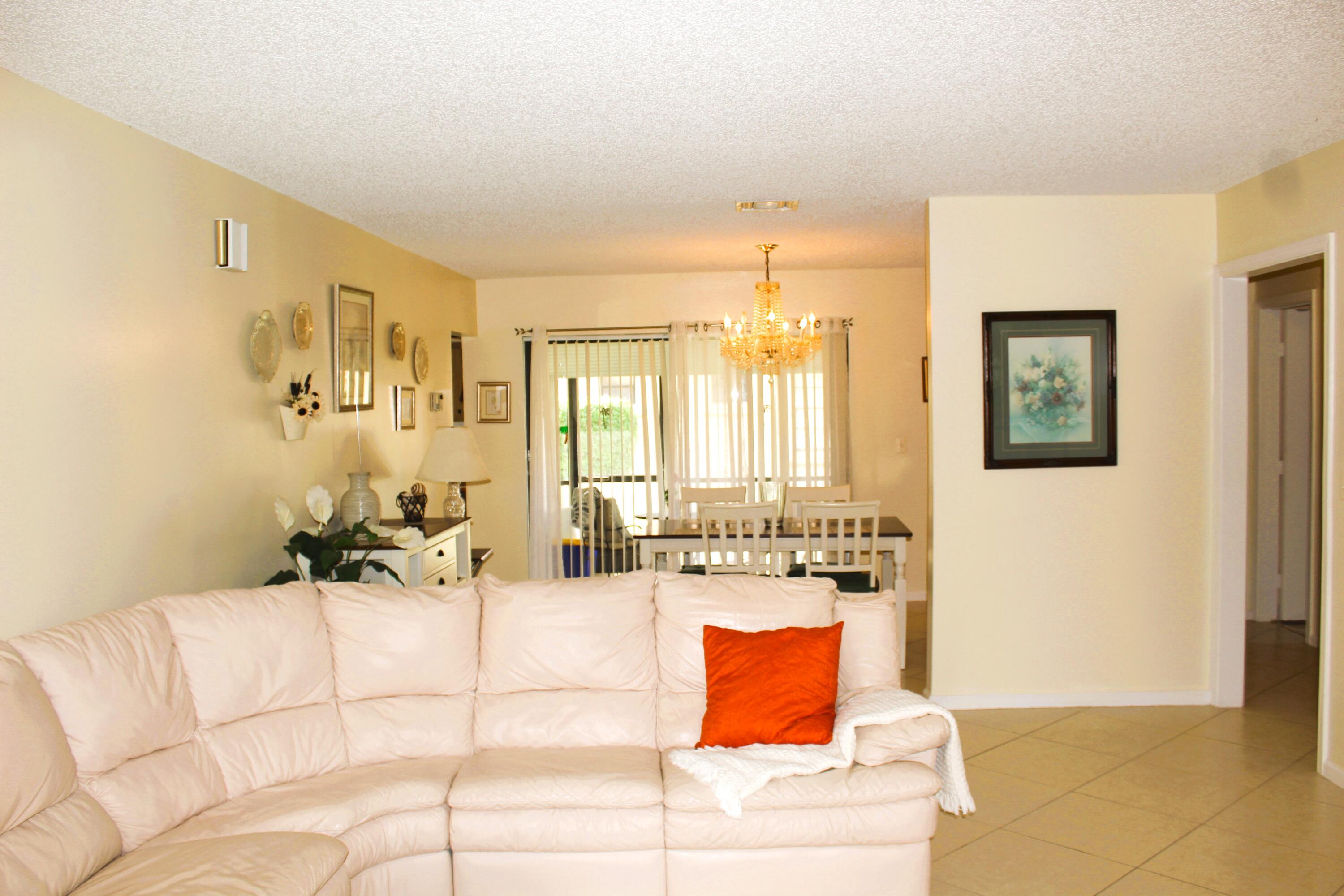 9825 Bischofia Tree Way, Unit B Boynton Beach, FL 33436 - Photo 2 of 12 a living room with furniture and a table