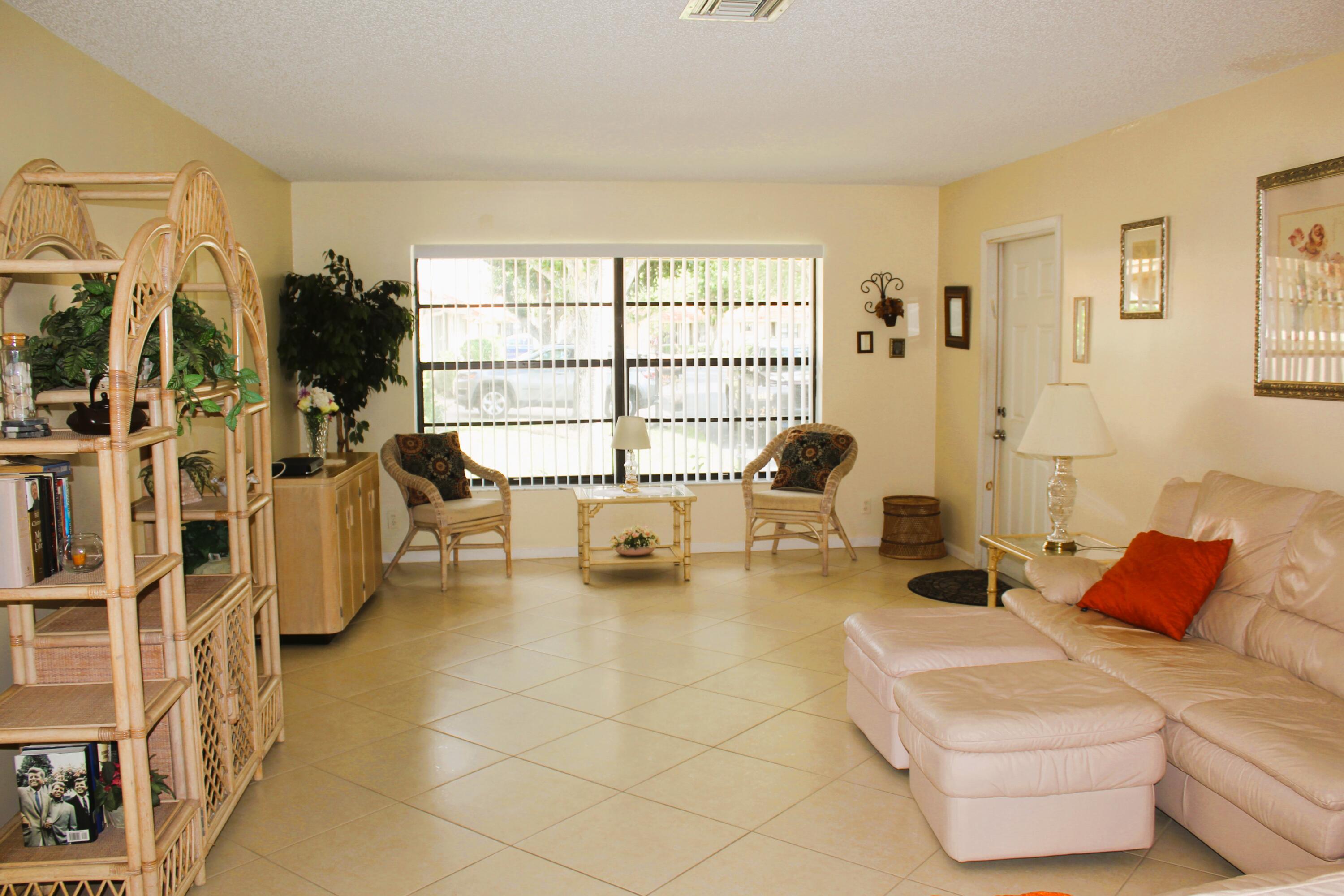 9825 Bischofia Tree Way, Unit B Boynton Beach, FL 33436 - Photo 3 of 12 a living room with furniture and a flat screen tv
