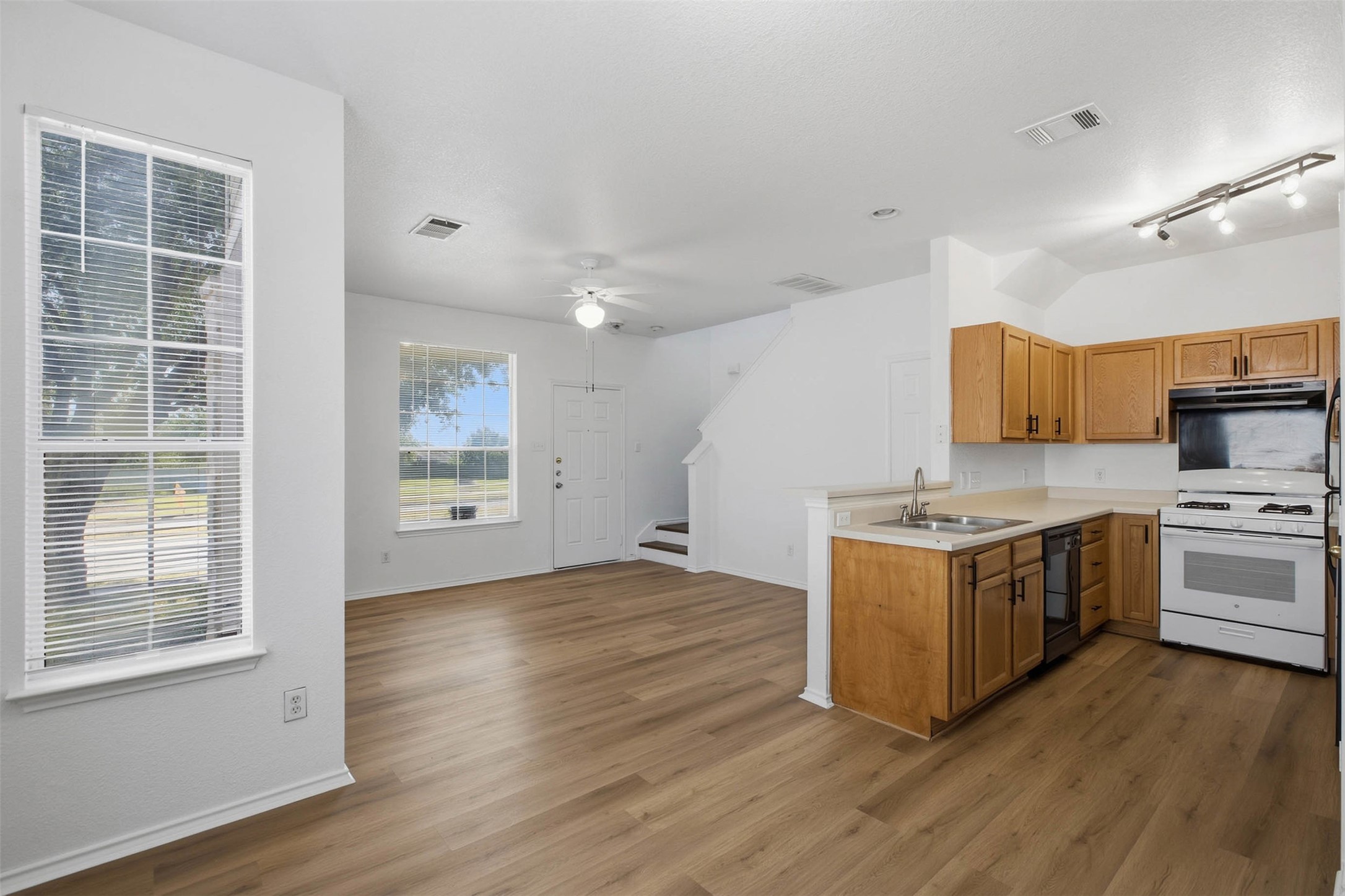 13808 Harris Ridge Boulevard, Unit B Pflugerville, TX 78660 - Photo 33 of 33 An open floor plan connects the living area seamlessly to the kitchen and staircase.