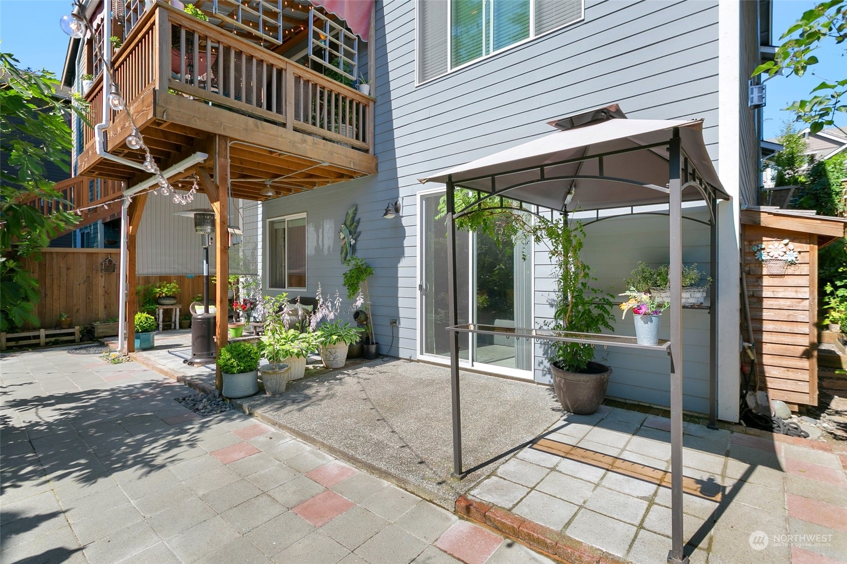 15931 Meridian Avenue South Bothell, WA 98012 - Photo 32 of 40 a view of a chair and tables in patio with potted plants