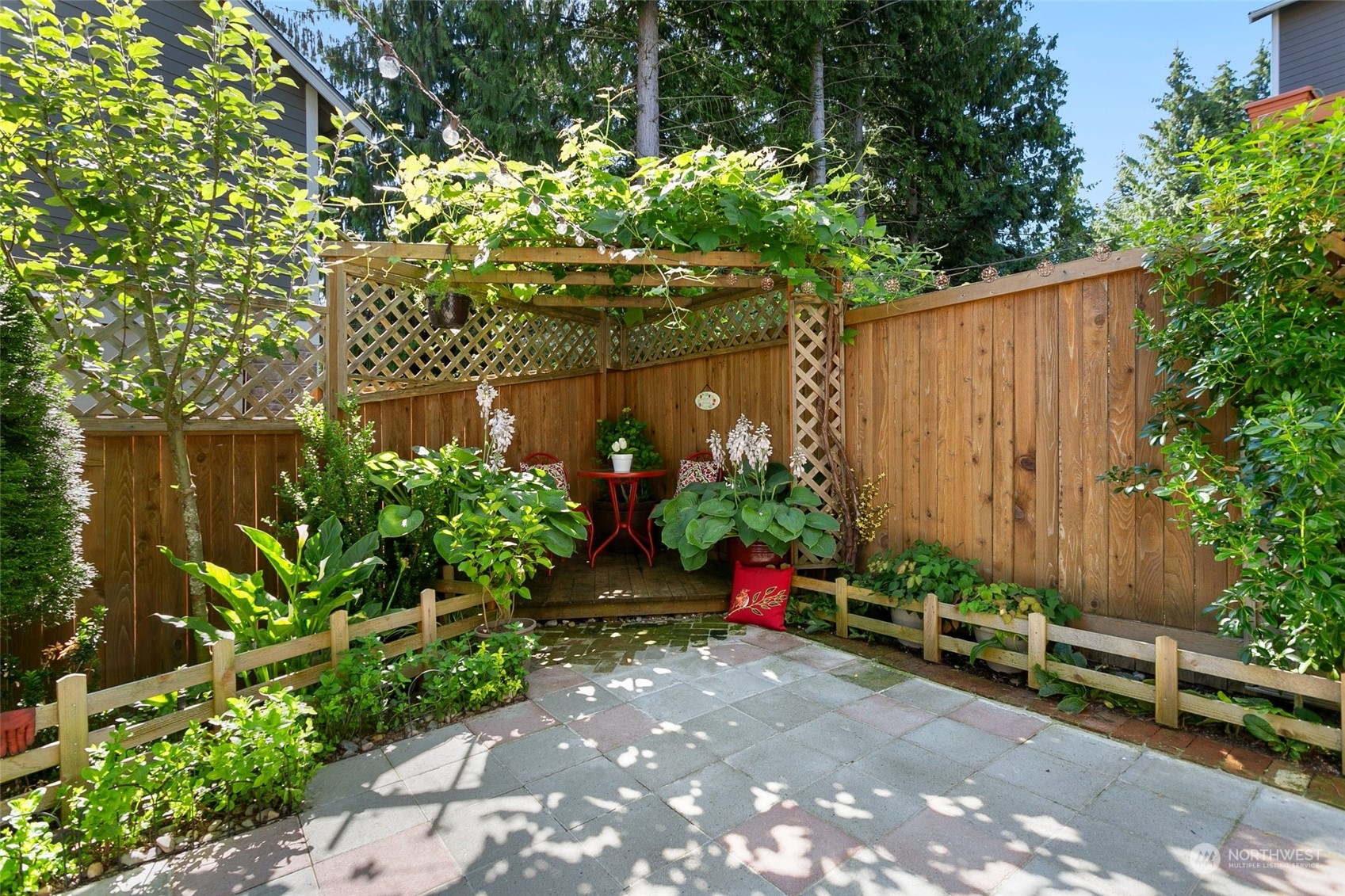 15931 Meridian Avenue South Bothell, WA 98012 - Photo 34 of 40 a view of a backyard with potted plants and large tree