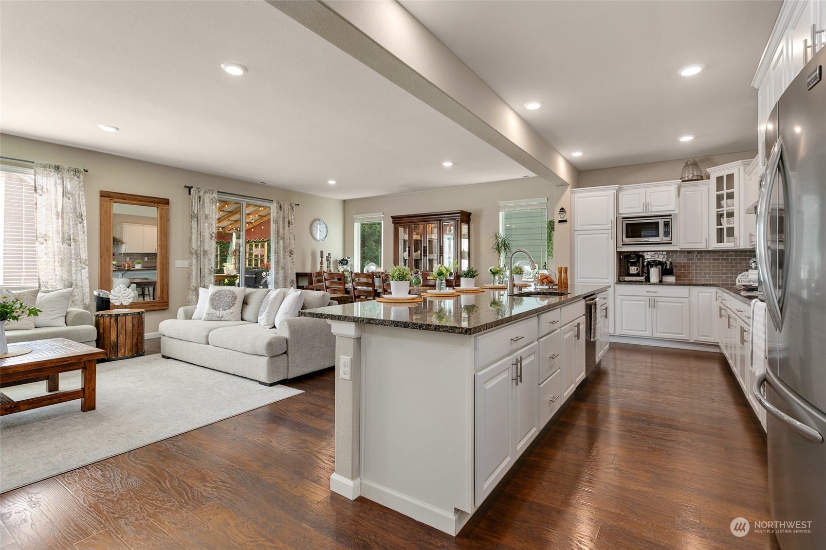 15931 Meridian Avenue South Bothell, WA 98012 - Photo 6 of 40 a large open kitchen with stainless steel appliances kitchen island a large counter top and a view of living room