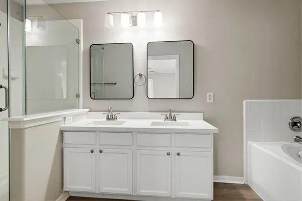 a bathroom with 2 sink and a mirror