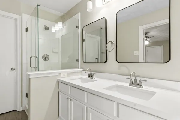 a bathroom with a double vanity sink mirror and