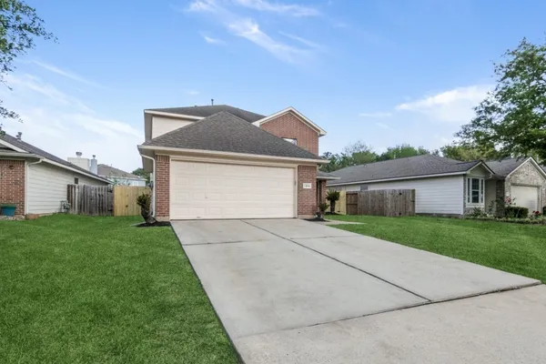 a front view of house with yard and trees