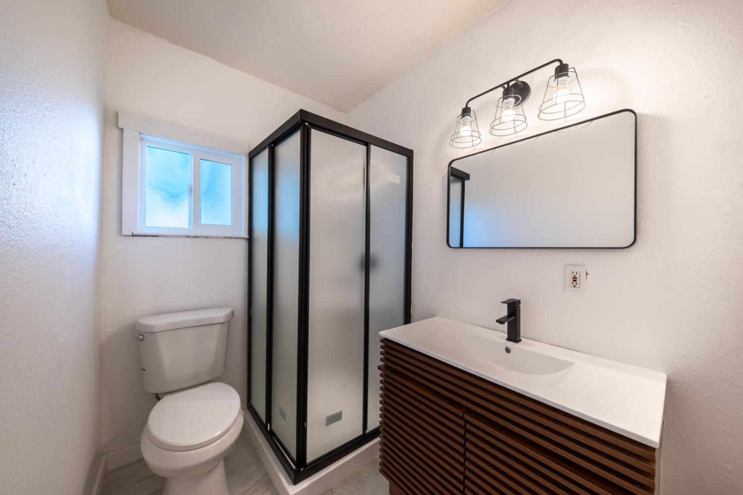 2790 Boles Street Madera, CA 93637 - Photo 14 of 19 a bathroom with a toilet sink and mirror