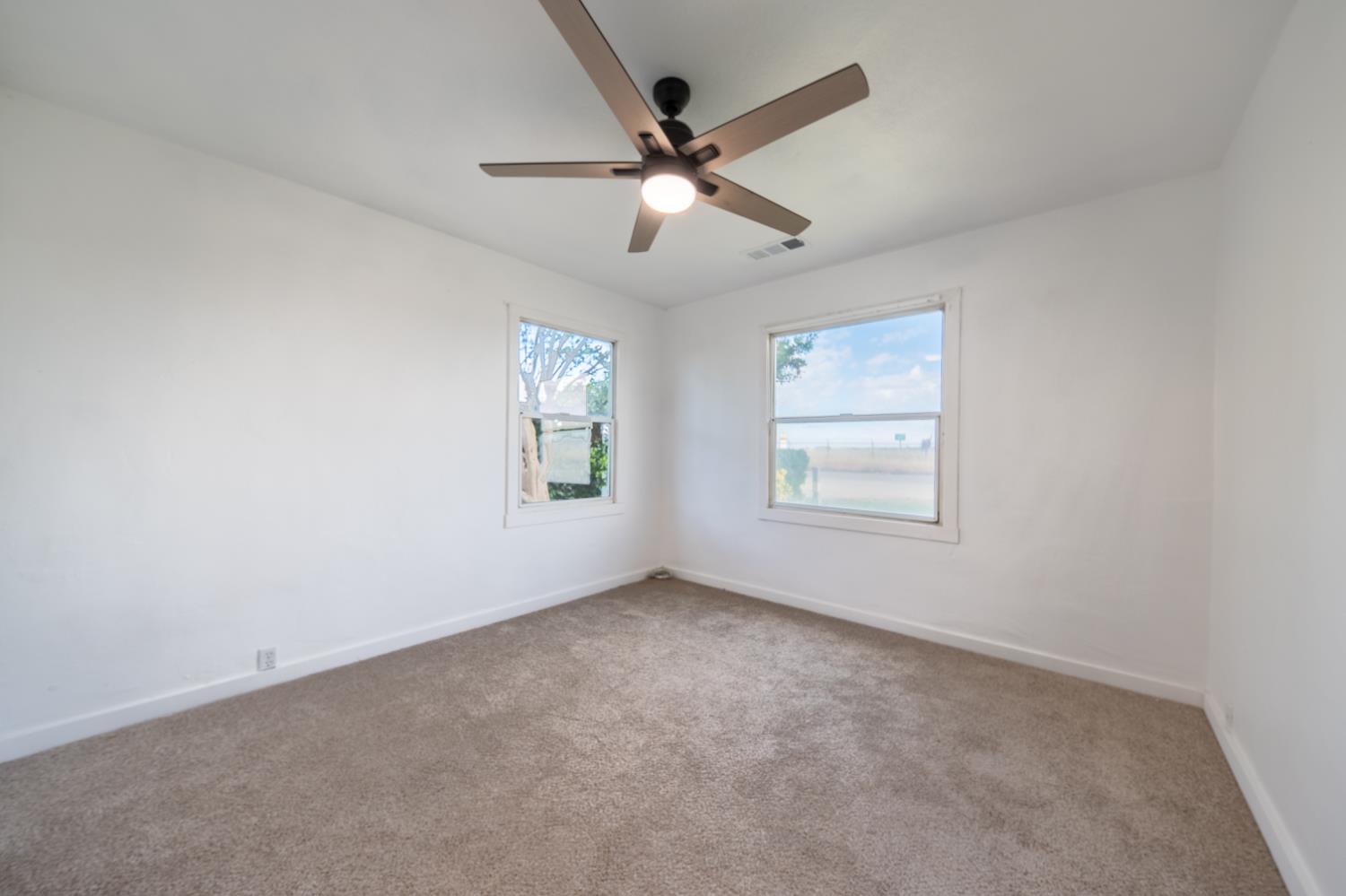 2790 Boles Street Madera, CA 93637 - Photo 15 of 19 an empty room with ceiling fan and windows