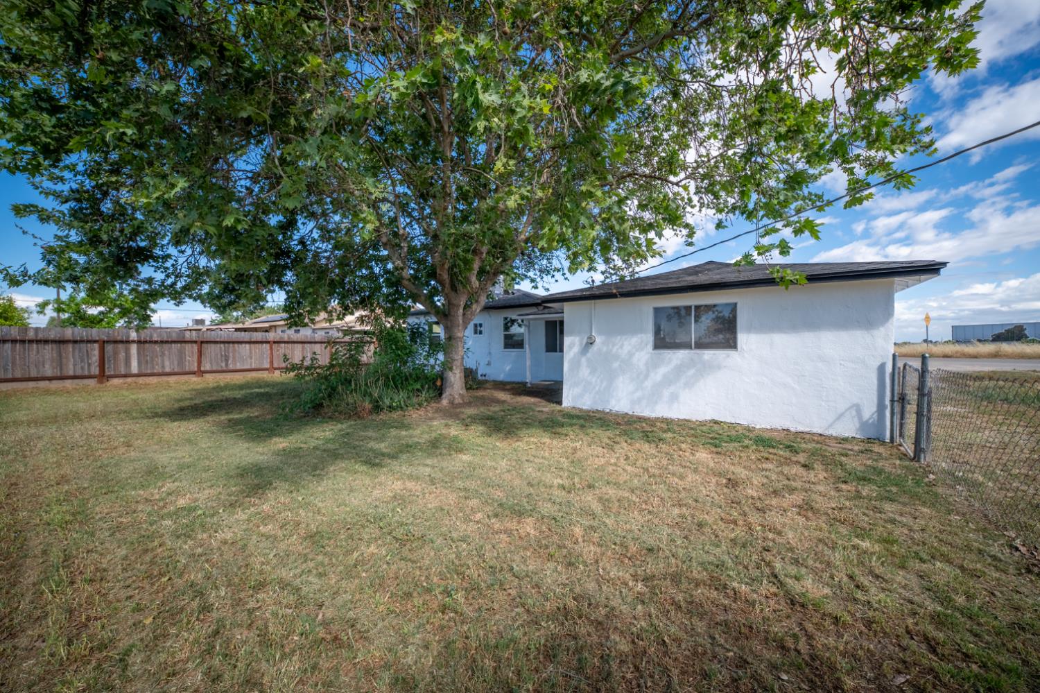 2790 Boles Street Madera, CA 93637 - Photo 19 of 19 a backyard of a house with plants and tree