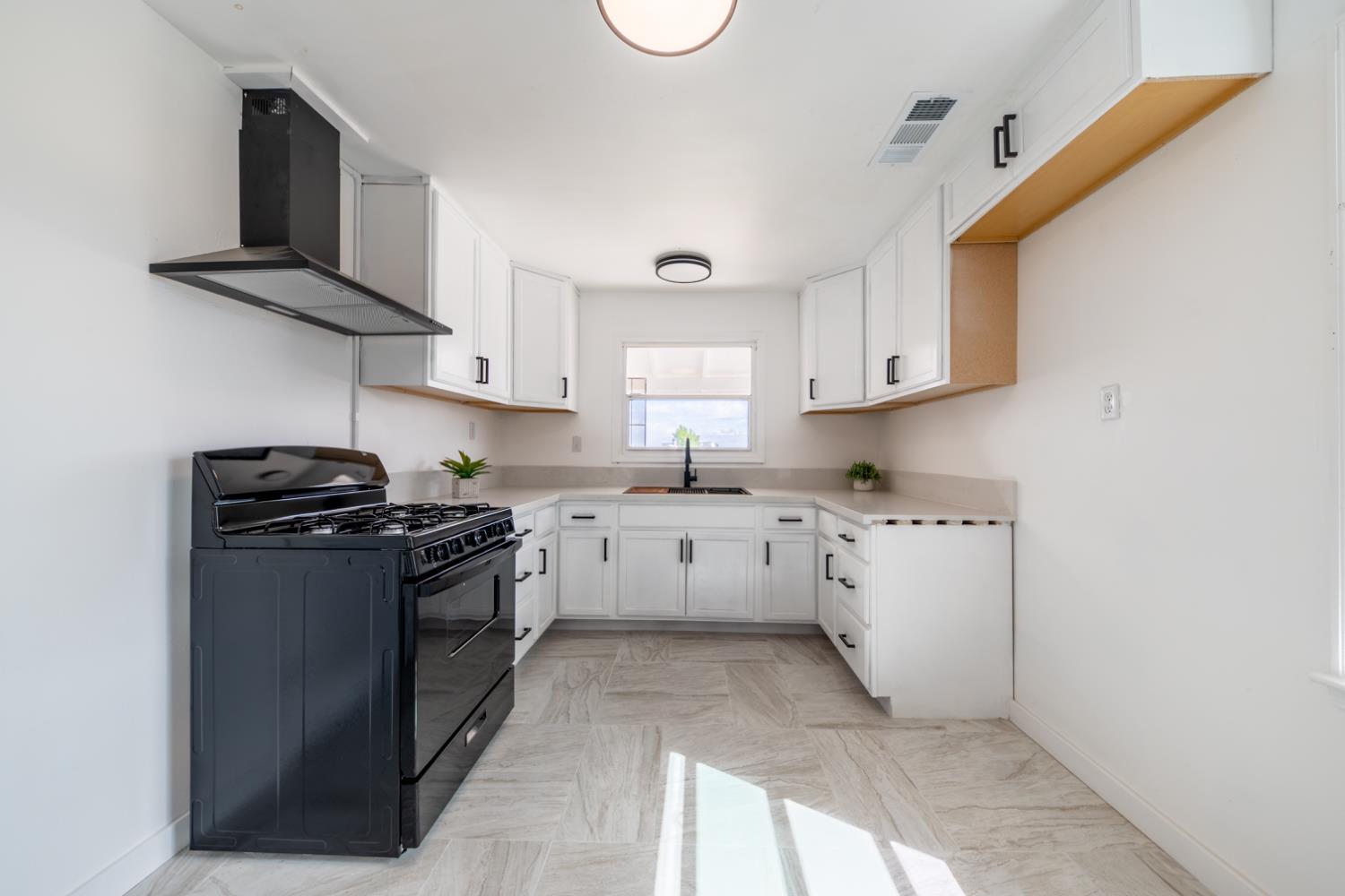 2790 Boles Street Madera, CA 93637 - Photo 8 of 19 a kitchen with appliances cabinets and a window