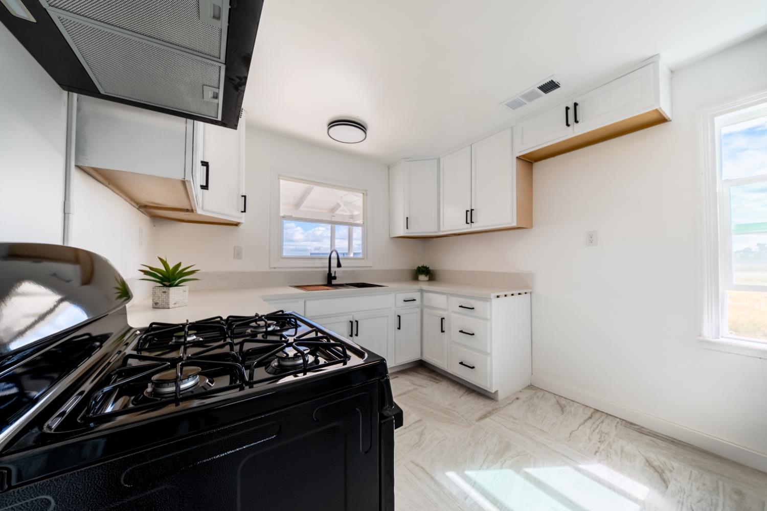 2790 Boles Street Madera, CA 93637 - Photo 10 of 19 a kitchen with white cabinets and appliances