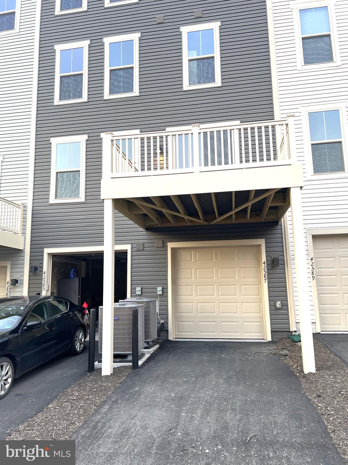 42587 Pitlochry Terrace Sterling, VA 20166 - Photo 18 of 25 a view of a house with a yard and garage
