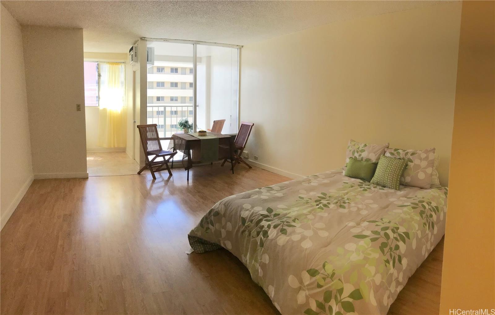 747 Amana Street, Unit 1211 Honolulu, HI 96814 - Photo 1 of 1 a bed sitting in a room next to a window