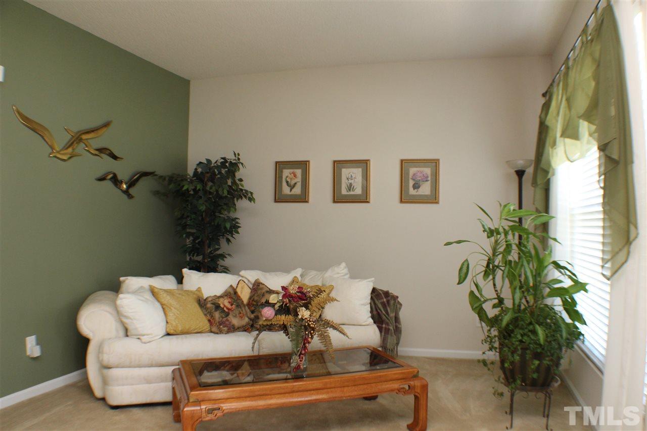 4016 Crowfield Drive Raleigh, NC 27610 - Photo 4 of 20 a living room with furniture and a potted plant