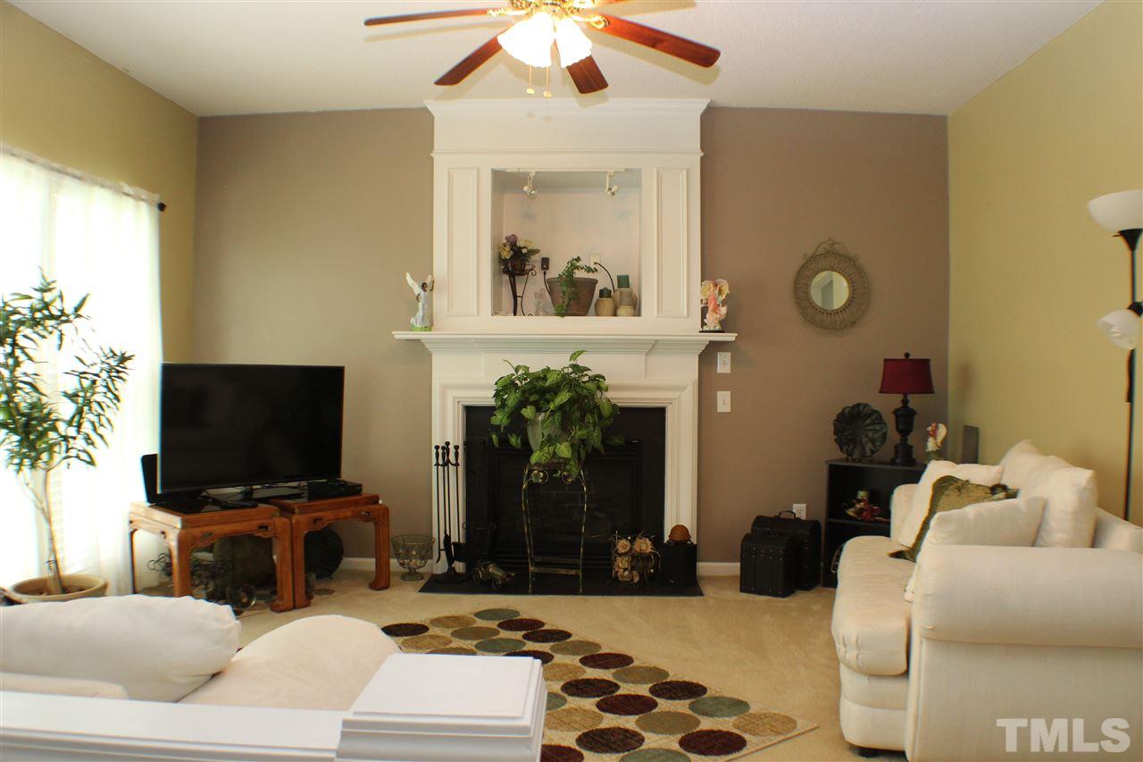 4016 Crowfield Drive Raleigh, NC 27610 - Photo 6 of 20 a living room with furniture and a flat screen tv