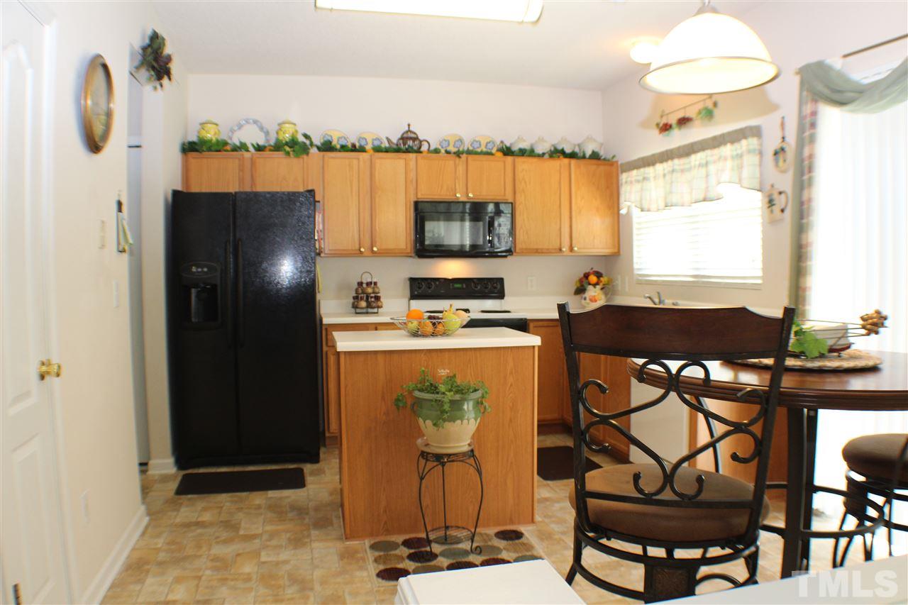 4016 Crowfield Drive Raleigh, NC 27610 - Photo 7 of 20 a dining room with table and chairs