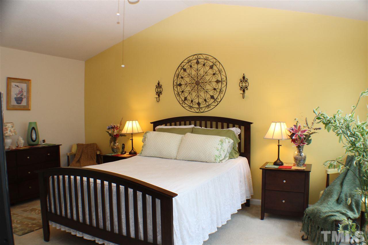 4016 Crowfield Drive Raleigh, NC 27610 - Photo 10 of 20 a bedroom with a bed and a potted plant