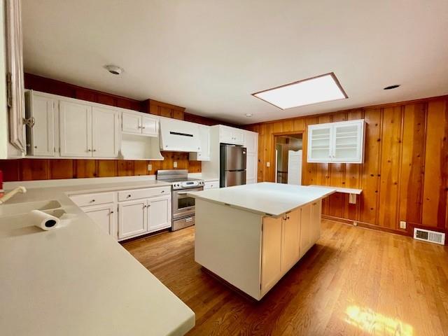 2396 Lavista Road Northeast Atlanta, GA 30329 - Photo 7 of 28 a kitchen that has a lot of white cabinets and wooden floor
