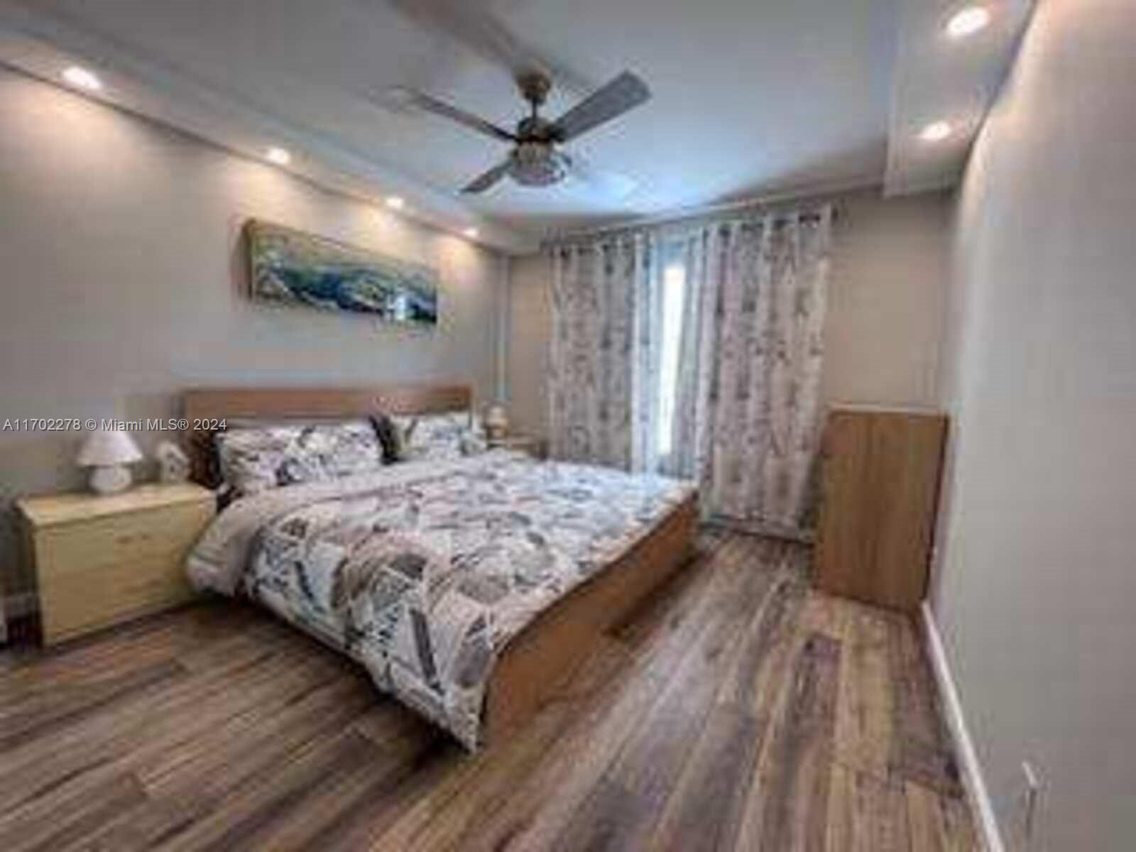 6299 La Costa Drive, Unit D Boca Raton, FL 33433 - Photo 12 of 23 a bedroom with a bed and a large window
