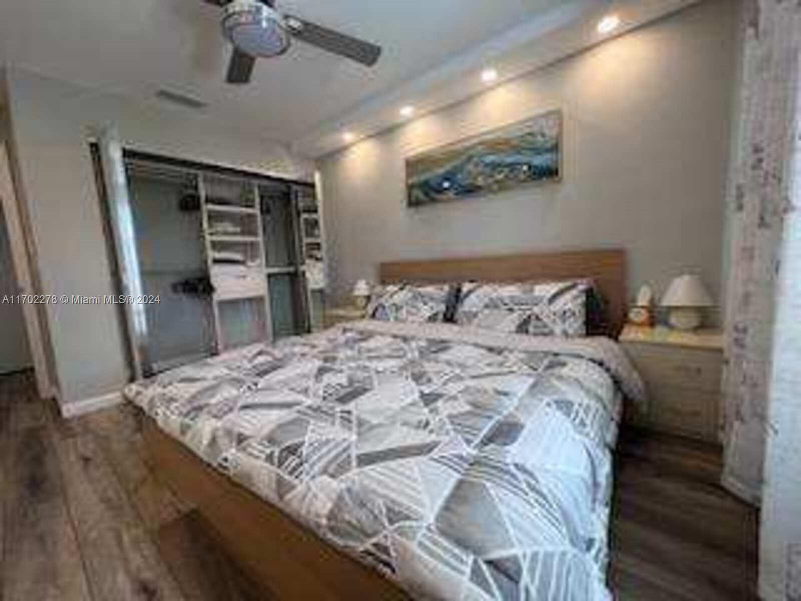 6299 La Costa Drive, Unit D Boca Raton, FL 33433 - Photo 14 of 23 a bedroom with a bed and a dresser