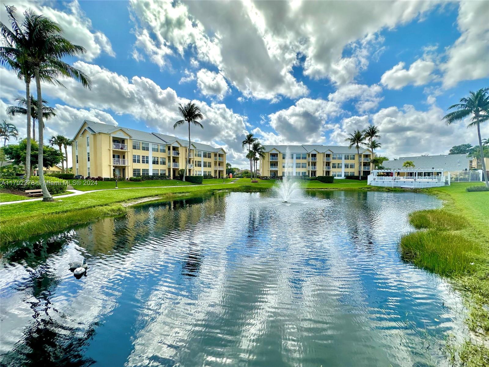 6299 La Costa Drive, Unit D Boca Raton, FL 33433 - Photo 2 of 23 a view of residential houses with outdoor space and lake view