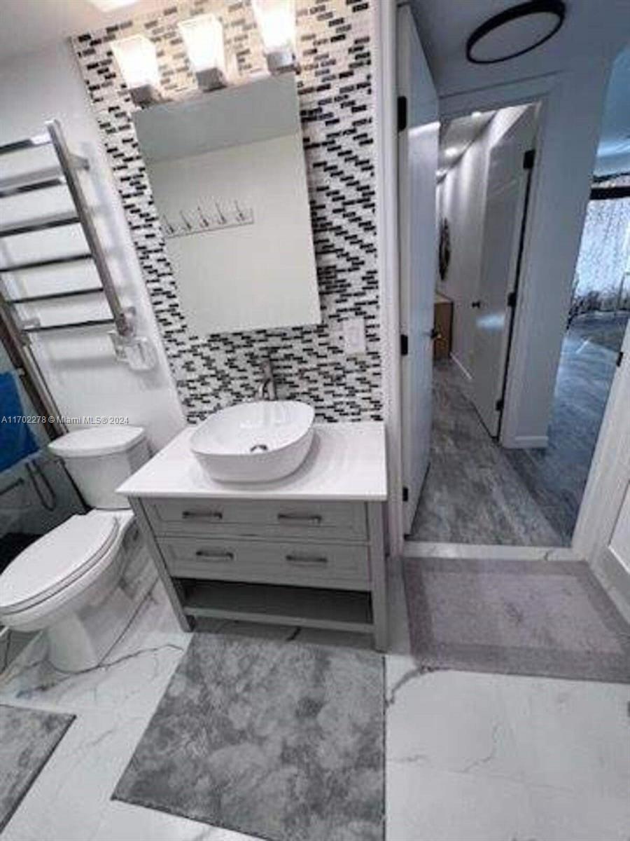 6299 La Costa Drive, Unit D Boca Raton, FL 33433 - Photo 21 of 23 a bathroom with a toilet and a sink