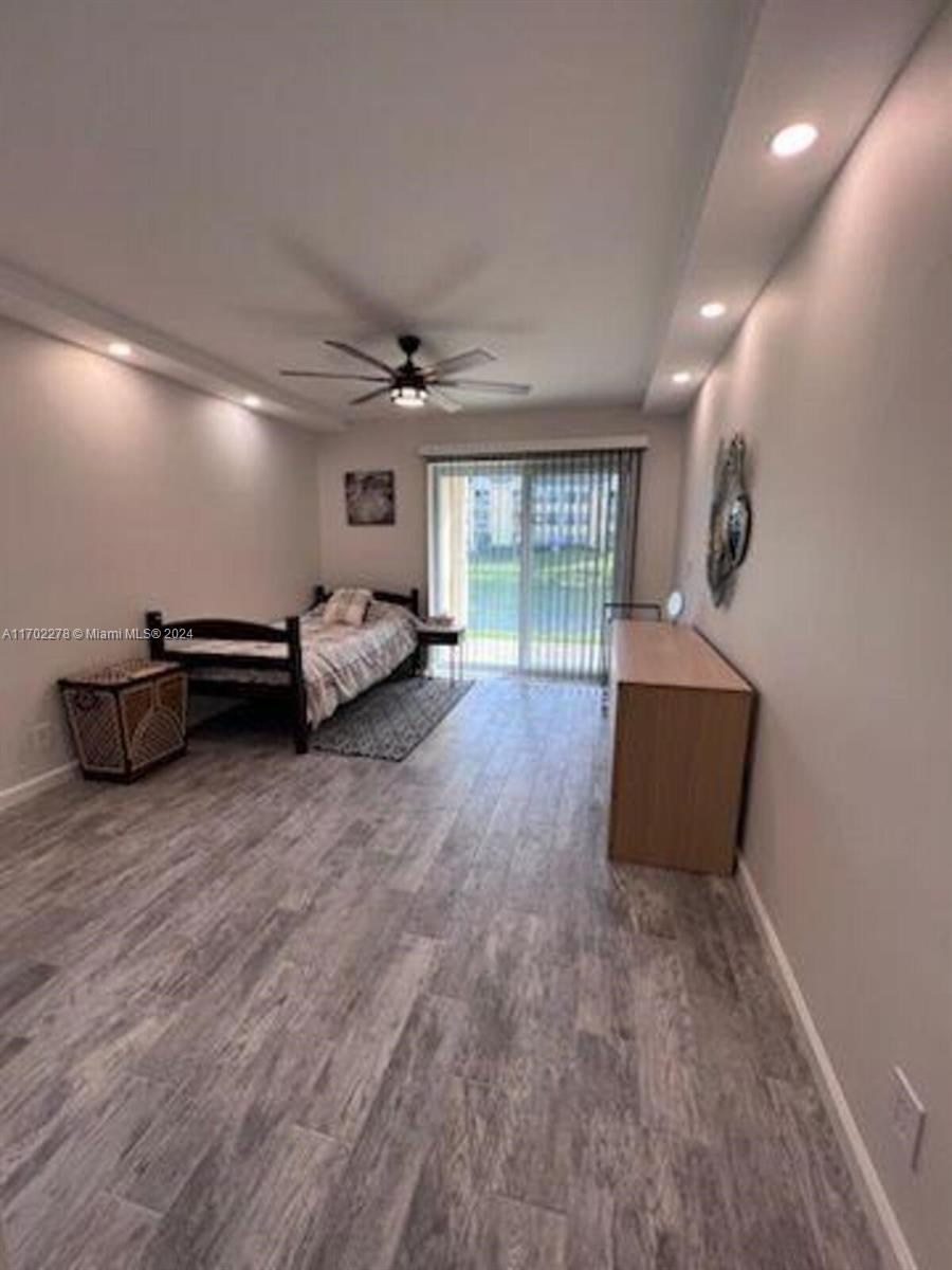 6299 La Costa Drive, Unit D Boca Raton, FL 33433 - Photo 22 of 23 a living room with furniture and a wooden floor