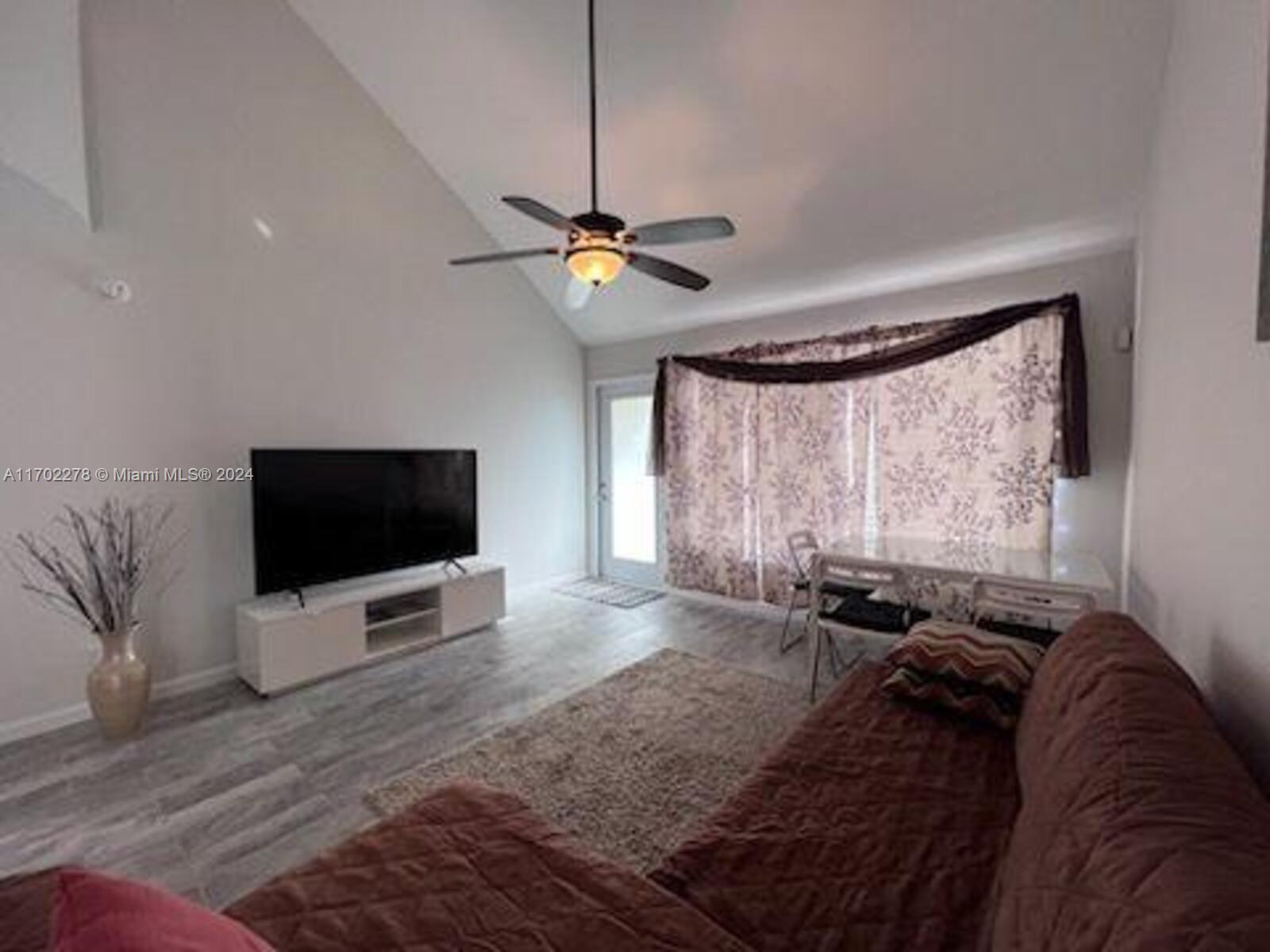 6299 La Costa Drive, Unit D Boca Raton, FL 33433 - Photo 3 of 23 a view of a livingroom with furniture and a flat screen tv
