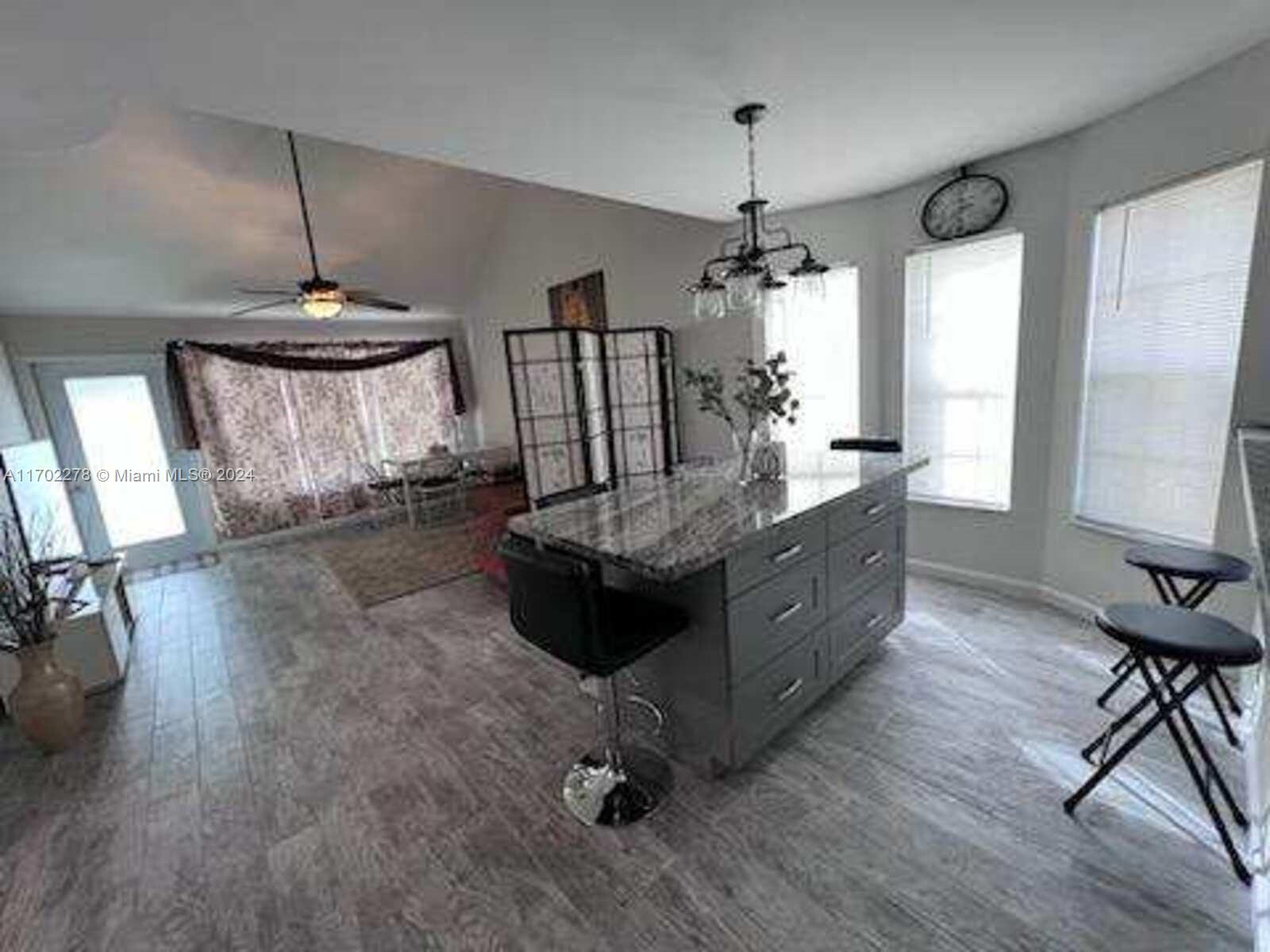 6299 La Costa Drive, Unit D Boca Raton, FL 33433 - Photo 4 of 23 a living room with furniture and a chandelier