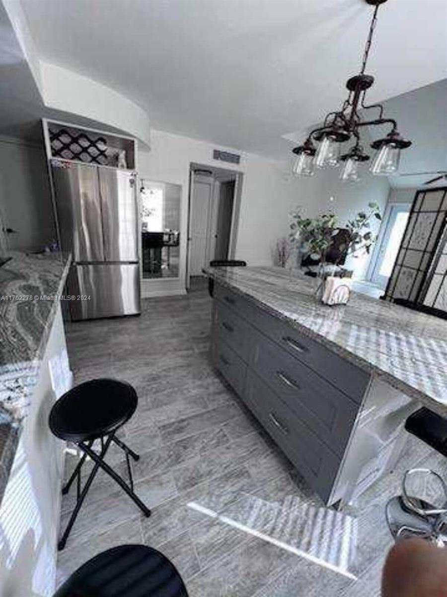 6299 La Costa Drive, Unit D Boca Raton, FL 33433 - Photo 10 of 23 a kitchen with stainless steel appliances granite countertop sink stove top oven and refrigerator