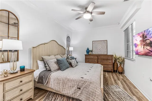 a bedroom with a bed and a lamp on dresser