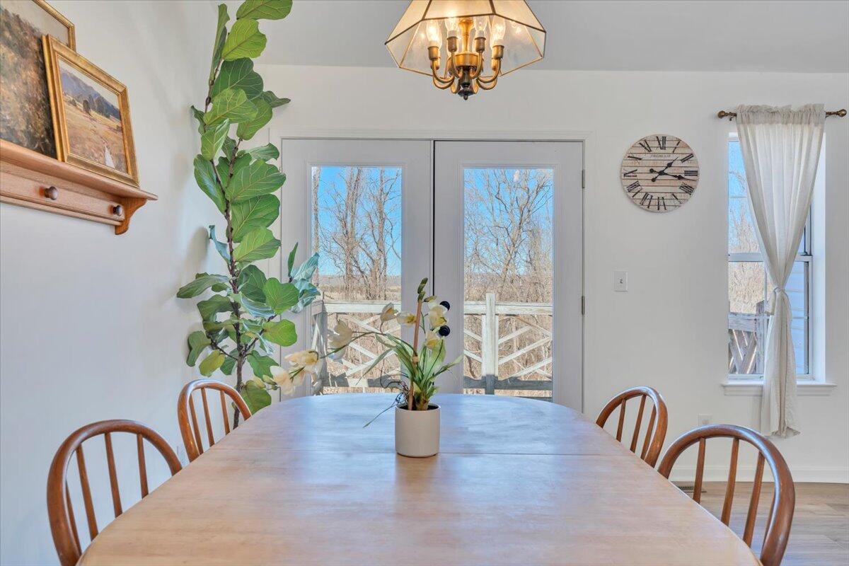432 Arch Mill Road Buchanan, VA 24066 - Photo 20 of 72 a view of a dining room with furniture a chandelier and wooden floor