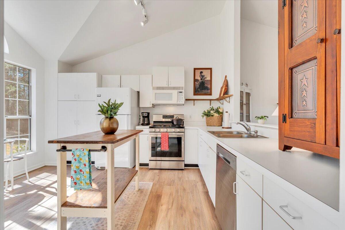432 Arch Mill Road Buchanan, VA 24066 - Photo 23 of 72 a kitchen with stainless steel appliances a white stove top oven a sink a dining table and chairs