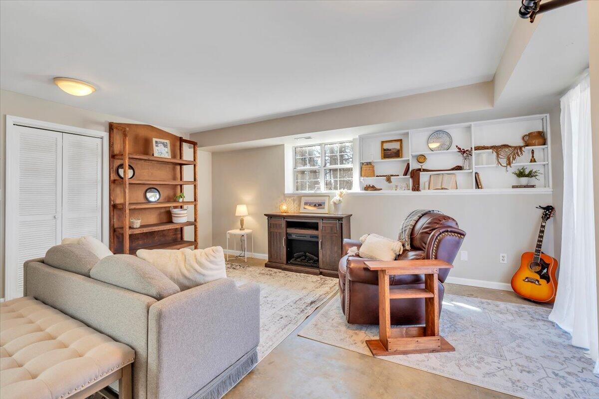 432 Arch Mill Road Buchanan, VA 24066 - Photo 46 of 72 a living room with furniture a fireplace and bookshelf
