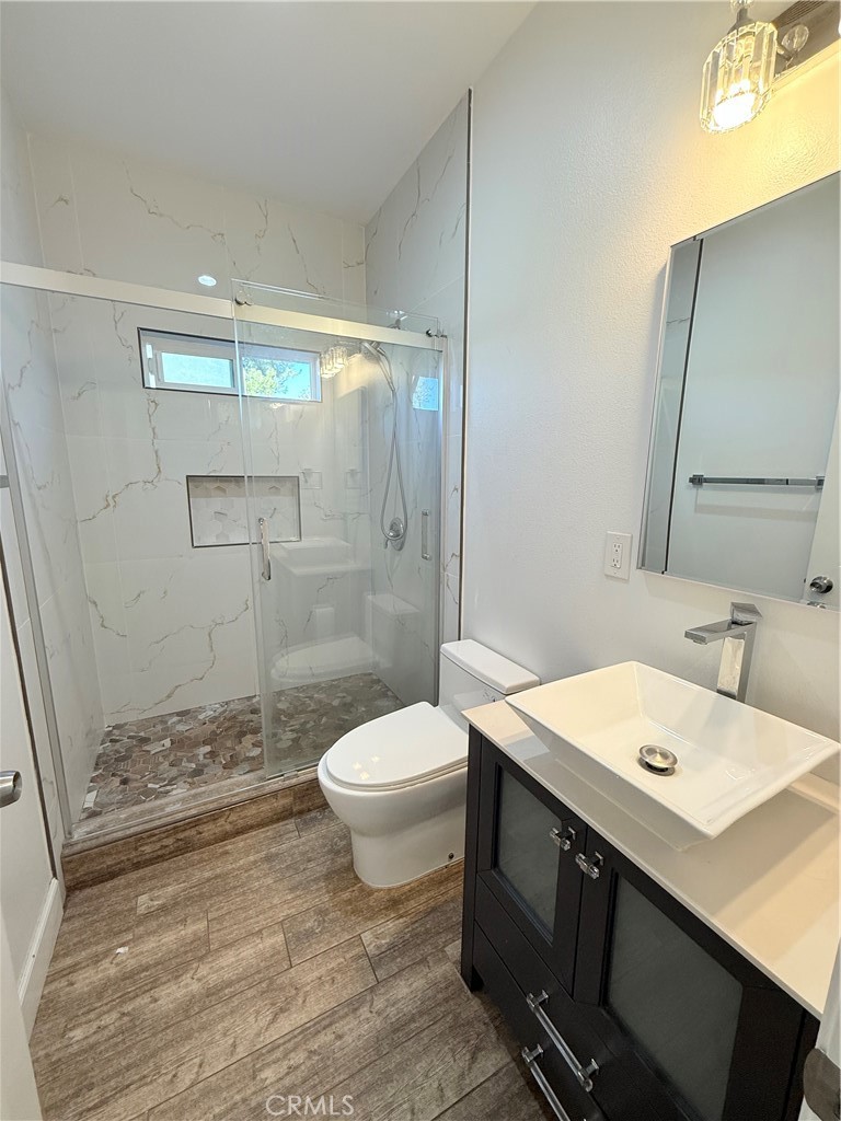 125 North Orangewood Street Colton, CA 92324 - Photo 7 of 12 a bathroom with a sink a toilet and shower