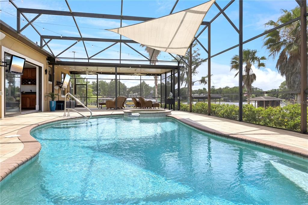 11325 Preston Cove Road Clermont, FL 34711 - Photo 28 of 58 a view of white house with a swimming pool