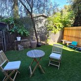 a view of a backyard with furniture and a backyard