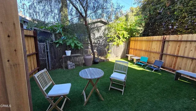 a view of a backyard with furniture and a backyard