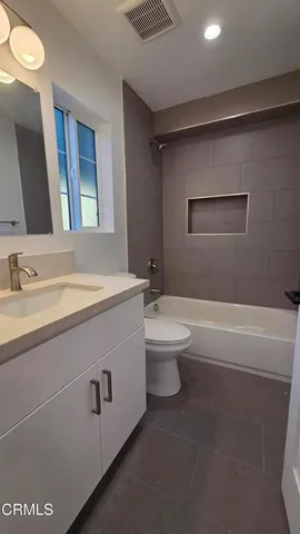 a bathroom with a sink a toilet and a bathtub