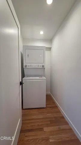 a view of washer and dryer with wooden floor