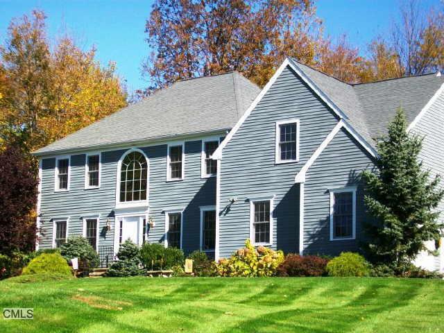a front view of a house with a garden and plants