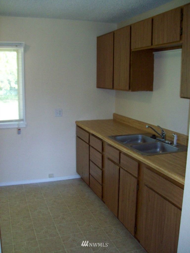 614 Index Avenue Northeast Renton, WA 98056 - Photo 6 of 14 a kitchen with a sink cabinets and a stove top oven