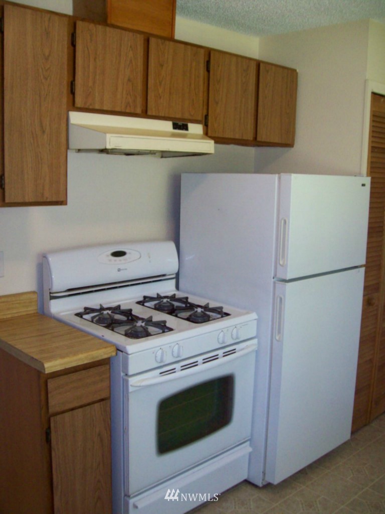 614 Index Avenue Northeast Renton, WA 98056 - Photo 9 of 14 a kitchen with stainless steel appliances granite countertop a stove and a refrigerator