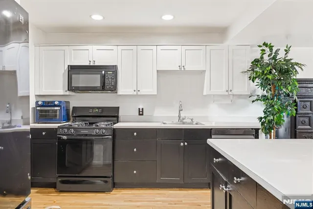 a kitchen with a sink stove and microwave