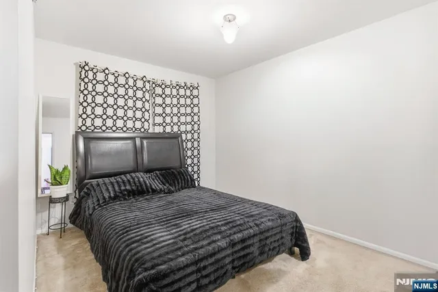 a bedroom with a bed and a wall painting