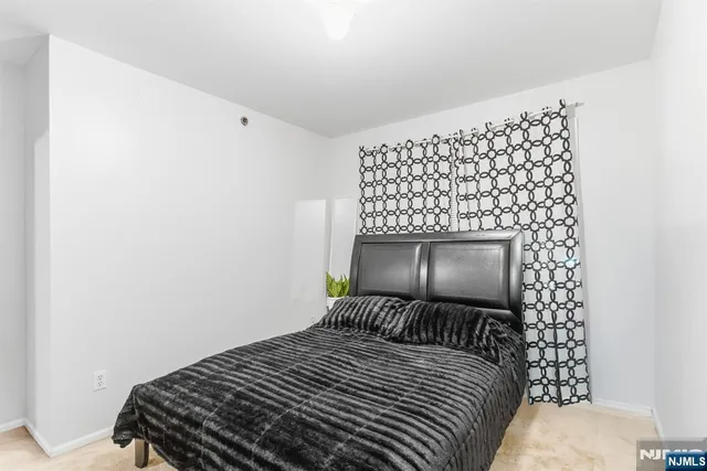 a bedroom with a bed and a wall painting