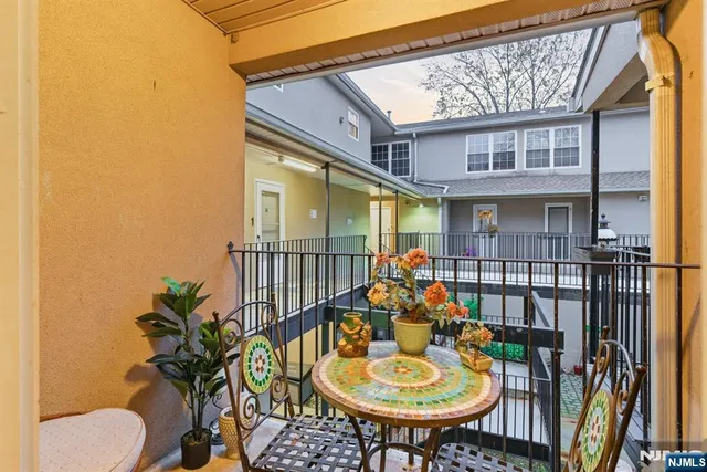 a balcony view with a seating space