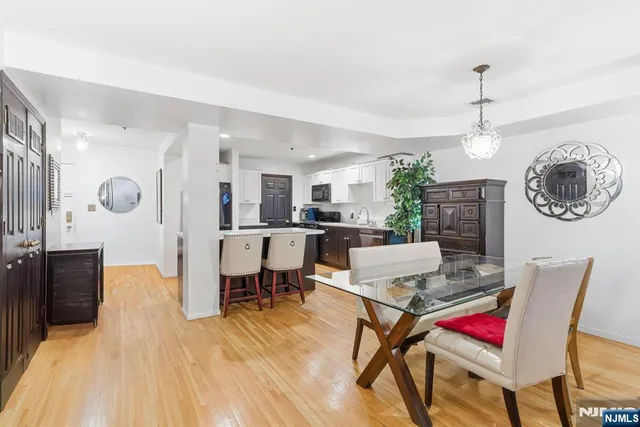 a living room with dining room and kitchen view